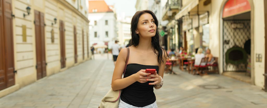 Woman in Bratislava after choosing the best credit cards to use in Europe.