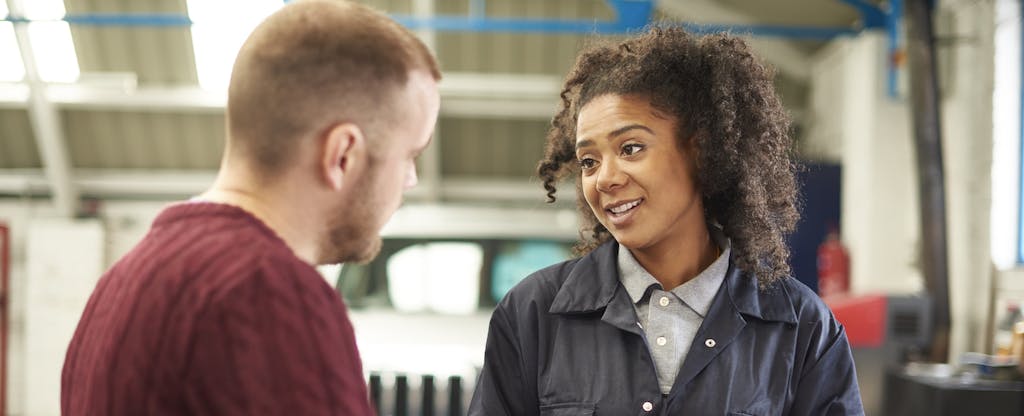 Mechanic explaining the cost of a car repair to car owner