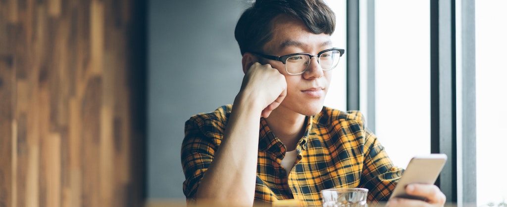 Young man looking up why thd cbna is on his credit report
