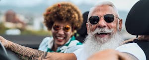 Couple sitting together in their convertible