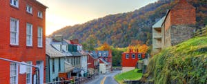 most-expensive-zip-codes A small town main street in West Virginia with a hillside and the setting sun in the background.